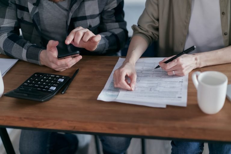 Two people discussing accounting records