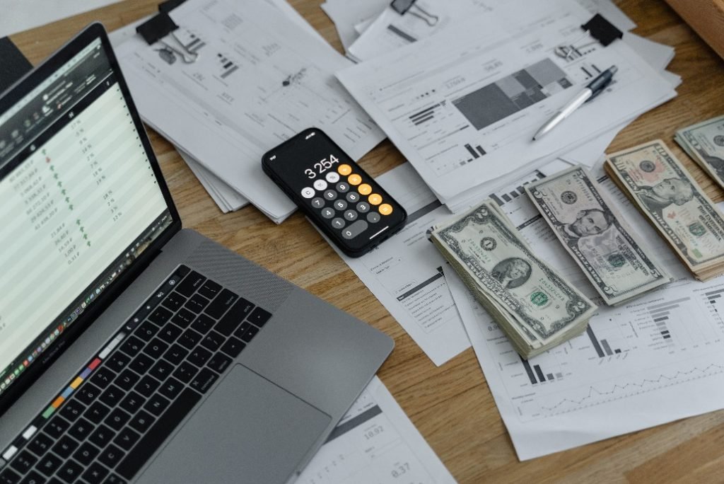 Banknotes, documents, and gadgets on a table