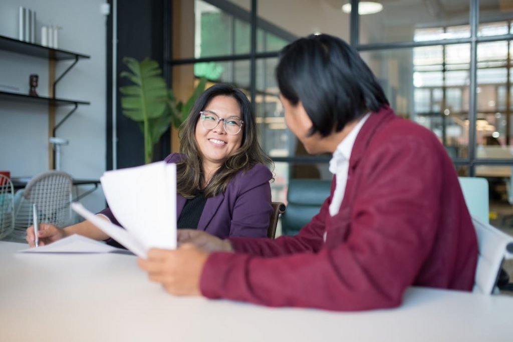 Two people discussing documents 