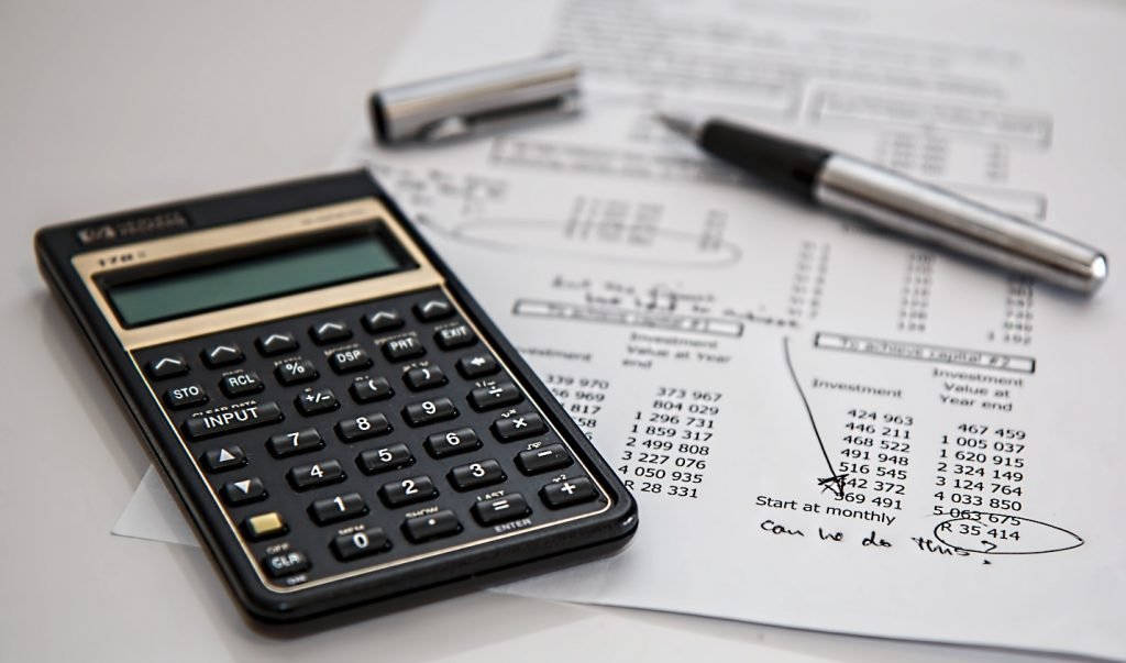 Calculator and a pen on a document